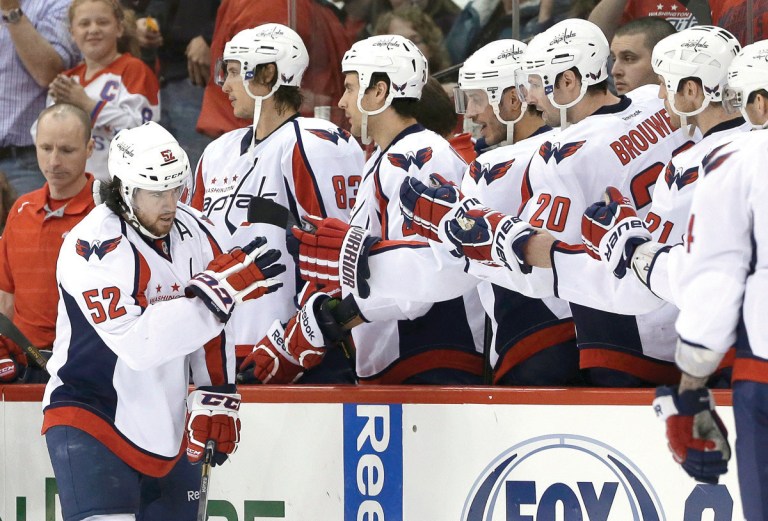 Gerry Broome/AP
Defenseman Mike Green celebrates with teammates after scoring the second of two goals in Washington's comeback win over Carolina.