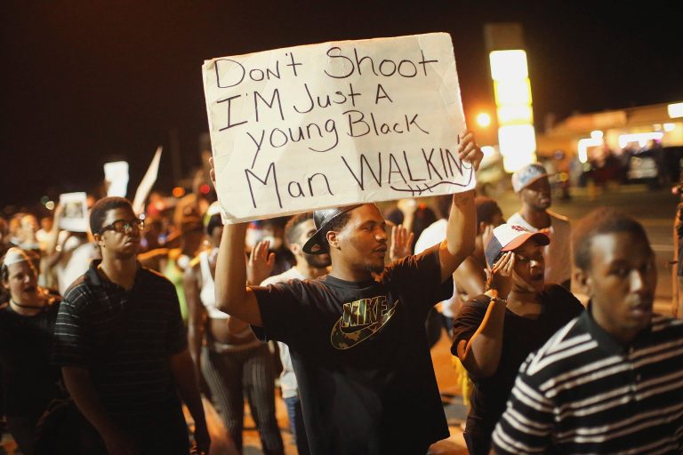 Demonstrators protest the killing of teenager Michael Brown on Aug. 19, 2014, in Ferguson, Mo. Brown was shot and killed by a Ferguson police officer on Aug. 9. (Photo by Scott Olson/Getty images)
