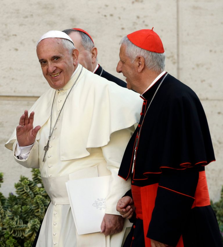 Pope Francis greets journalists as he walks alongside Vatican Secretary of State Pietro Parolin, background left, and Cardinal Giuseppe Versaldi, as he arrives for an afternoon session of a two-week synod on family issues at the Vatican, Wednesday, Oct. 8, 2014. (AP Photo/Gregorio Borgia)