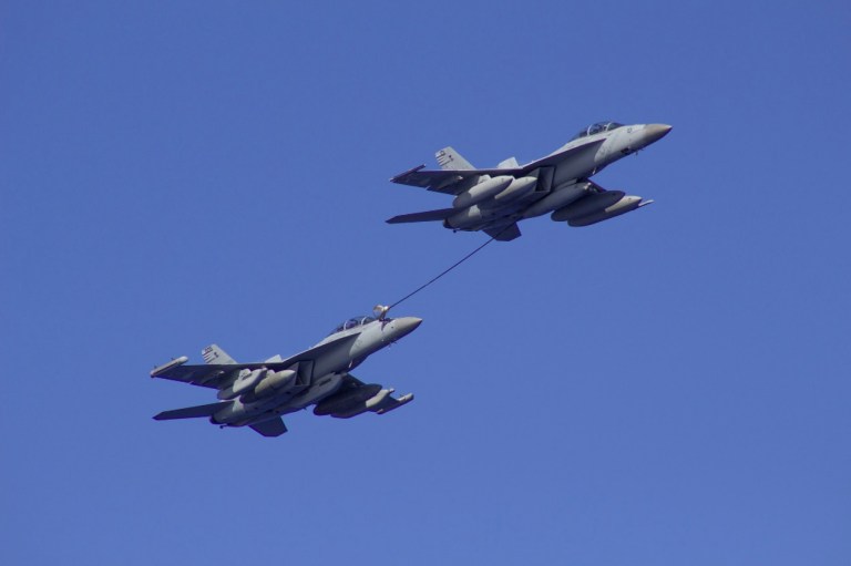 An F/A-18 Super Hornet (left) refuels an EA-18G Growler. Both types of aircraft were grounded on Friday after an incident and have since been cleared to fly again. (Navy photo)