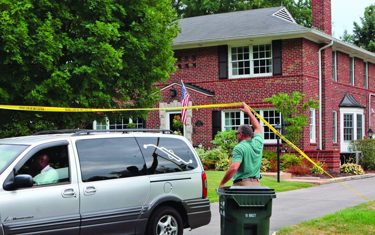 Glendale detectives lift the yellow tape to allow a hearse to leave a home following a murder-suicide in Glendale, Mo., on July 30, 2012. Nearly two dozen investigators with the St. Louis Area Major Case Squad were looking into the shootings deaths of a suburban St. Louis woman and her two children, police said Tuesday. Police haven't officially released the victims' names, but have said the children who were killed were ages 11 and 9. (AP Photo/St. Louis Post-Dispatch, J.B. Forbes) EDWARDSVILLE INTELLIGENCER OUT; THE ALTON TELEGRAPH OUT