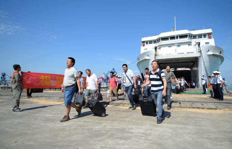 In this photo released by China's Xinhua News Agency, Chinese nationals disembark from the passenger vessel 