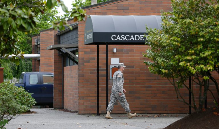 A solider walks Wednesday, June 5, outside the building housing the military courtroom where U.S. Army Staff Sgt. Robert Bales was taking part in a plea hearing at Joint Base Lewis-McChord in Washington state. Bates charged with killing 16 Afghan civilians pleaded guilty Wednesday. (AP Photo/Ted S. Warren)