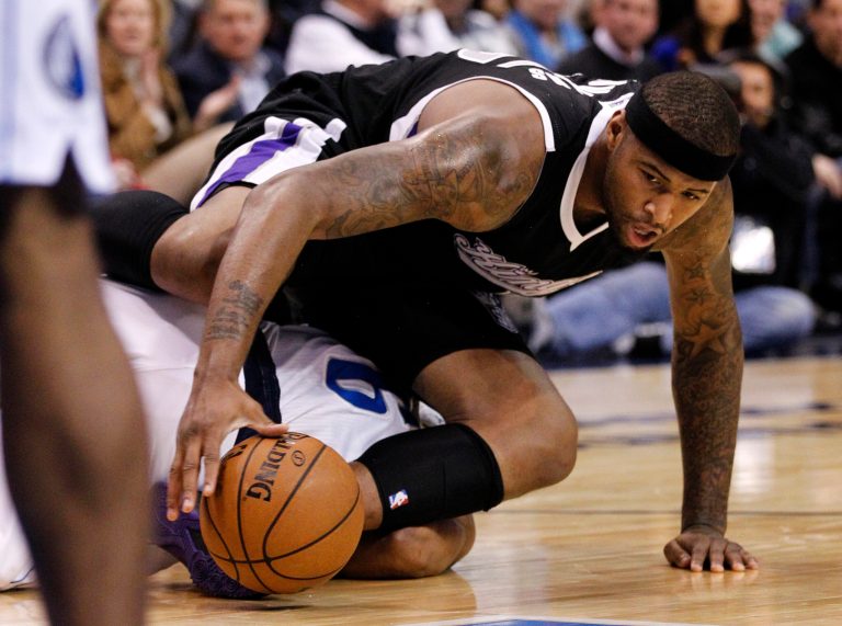   Sacramento Kings center DeMarcus Cousins, top, lands on top of Dallas Mavericks' Derek Fisher (6) chasing a loose ball in the first half of an NBA basketball game Monday, Dec. 10, 2012, in Dallas. (AP Photo/Tony Gutierrez)  