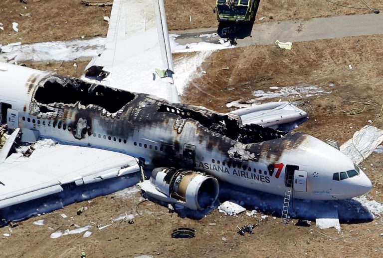 FILE - This July 6, 2013, file photo, shows the wreckage of the Asiana Flight 214 airplane after it crashed at the San Francisco International Airport in San Francisco. The pilots of Asiana Flight 214, as well as the airline, are raising the possibility that a key device that controls the Boeing 777's speed may have malfunctioned, an aviation expert familiar with the investigation into the crash said Tuesday, Oct. 8, 2013. (AP Photo/Marcio Jose Sanchez, File)