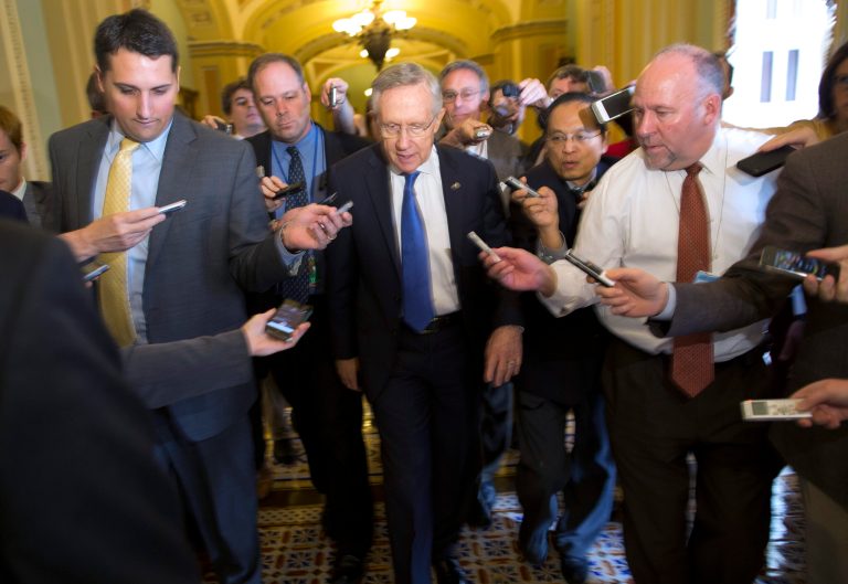 Senate Majority Leader Sen. Harry Reid, D-Nev., is surrounded by reporters after leaving the office of Senate Minority Leader Sen. Mitch McConnell, R-Ken., on Capitol Hill on Monday, Oct. 14, 2013 in Washington. Reid reported progress Monday towards a deal to avoid a threatened default and end a two-week partial government shutdown as President Barack Obama called congressional leaders to the White House to press for an end to the impasse. 