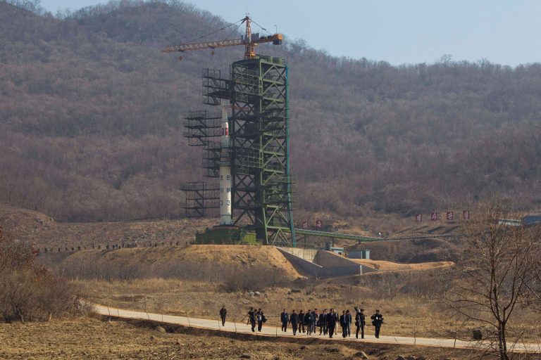   FILE - In this April 8, 2012 file photo, a group of journalists walk down a road in front of North Korea's Unha-3 rocket at Sohae Satellite Station in Tongchang-ri, North Korea. April 8, 2012. North Korea said Saturday, Dec. 1, 2012 it will launch a long-range rocket between Dec. 10 and Dec. 22. The launch will heighten already strained tensions with South Korean ahead of its presidential election on Dec. 19. (AP Photo/David Guttenfelder, File)  