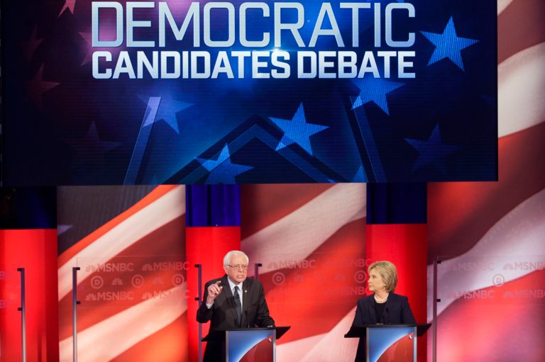 Democratic presidential candidate, Sen. Bernie Sanders, I-Vt, answers a question as Democratic presidential candidate, Hillary Clinton listens during a Democratic presidential primary debate hosted by MSNBC at the University of New Hampshire Thursday, Feb. 4, 2016, in Durham, N.H. (AP Photo/David Goldman)