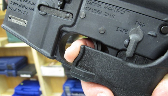 A gun store employee demonstrates how a "bump" stock works. The gunman who unleashed hundreds of rounds of gunfire on a crowd of concertgoers in Las Vegas attached what is called a "bump-stock" to two of his weapons, in effect converting semiautomatic firearms into fully automatic ones. (AP Photo/Allen Breed, File)