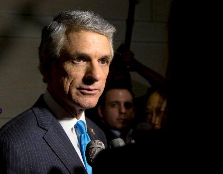 FILE - This Sept. 1, 2013, file photo shows Rep. Scott Rigell, R-Va, as he talks with media before entering a classified members-only briefing on Syria by senior administration officials on Capitol Hill, in Washington. Little of the impassioned debate that fractured lawmakers last year over possible military intervention in Syria is happening now as American war planes strike extremist targets in Iraq. (AP Photo/Carolyn Kaster, File)