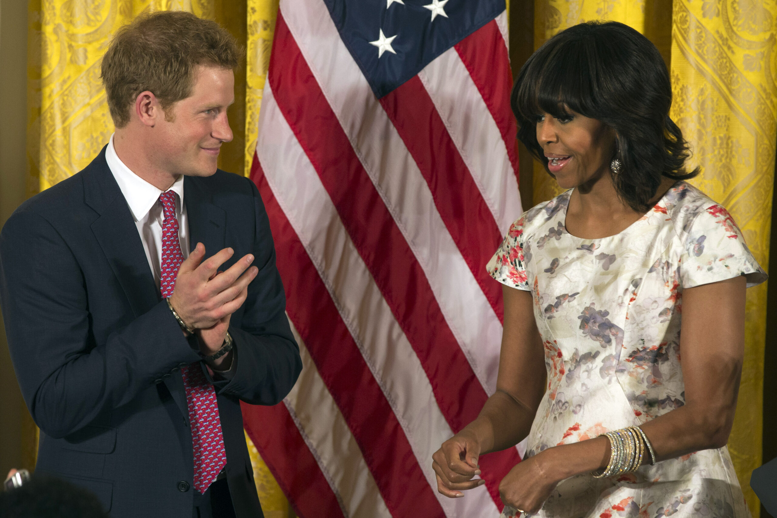 Prince Harry joins Michelle Obama to visit injured troops