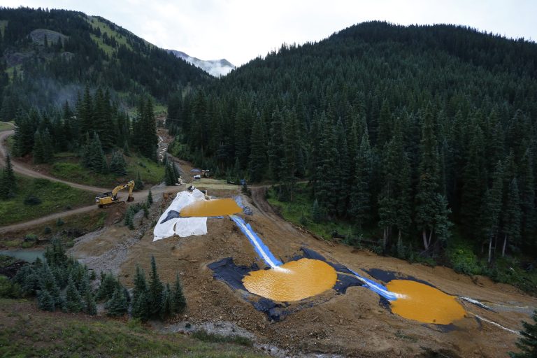 Water flows through a series of retention ponds built to contain and filter out heavy metals and chemicals from the Gold King mine chemical accident, in the spillway about 1/4 mile downstream from the mine, outside Silverton, Colo. (AP Photo/Brennan Linsley, File)