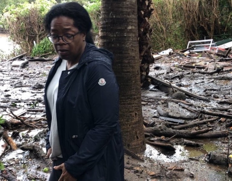 Oprah Winfrey standing in debris and mud flow as she looks at her neighbor's property in Montecito, Calif. On this Instagram post, she said her home wasn't damaged.