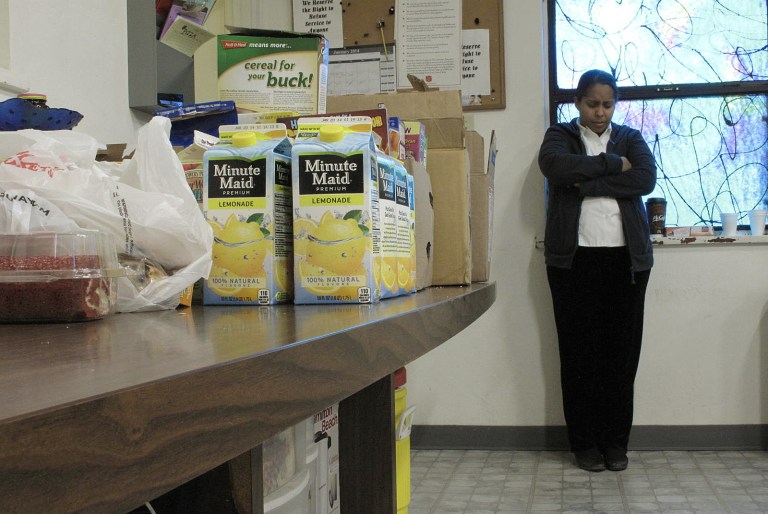 In this Jan. 30 photo, Felicia Grant, a lieutenant at the Salvation Army listens to a devotional before handing out free food to needy residents in Los Banos, Calif. (AP/Scott Smith)

