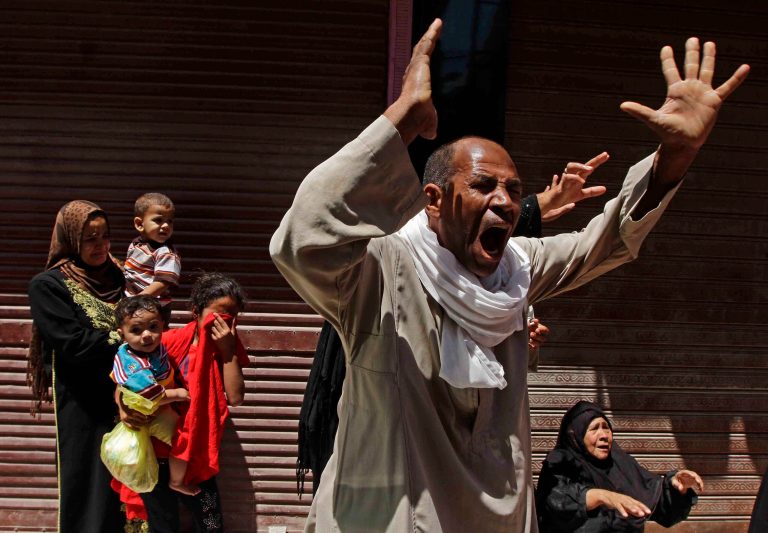 Relatives of a Muslim Brotherhood member who was sentenced to death react to the verdict outside a courtroom in Minya, Egypt, Saturday, June 21, 2014. The Muslim Brotherhood's Supreme Guide, Mohammed Badie and over 180 others were sentenced to death Saturday by an Egyptian court in the latest mass trial following last year's overthrow of the country's Islamist president. The ruling by the southern Minya Criminal Court is the largest confirmed mass death sentence to be handed down in Egypt in recent memory. The court acquitted more than 400 others in the case and family members of the accused wailed or cheered the verdicts. (AP Photo/Ravy Shaker, El Shorouk newspaper)    EGYPT OUT