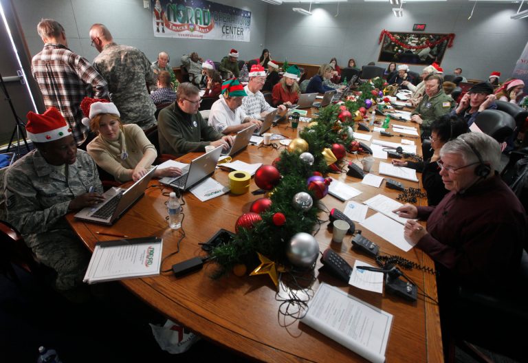   Volunteers take phone calls from children asking where Santa is and when he will deliver presents to their house, during the annual NORAD Tracks Santa Operation, at the North American Aerospace Defense Command, or NORAD, at Peterson Air Force Base, in Colorado Springs, Colo., Monday Dec. 24, 2012. Over a thousand volunteers at NORAD handle more than 100,000 thousand phone calls from children around the world every Christmas Eve, with NORAD continually projecting Santa's supposed progress delivering presents. (AP Photo/Brennan Linsley)  
