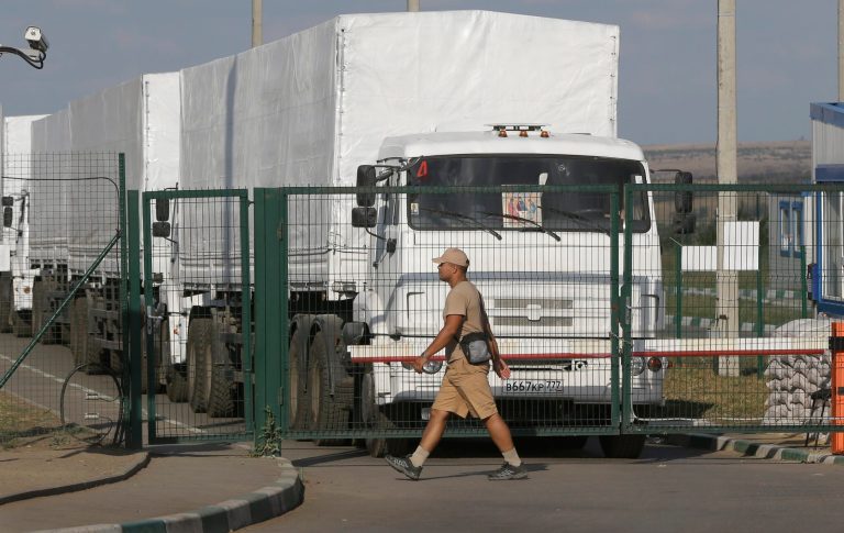 First trucks of the Russian aid convoy stand in the Russian inspection zone inside a border control point with Ukraine, in the Russian town of Donetsk, Rostov-on-Don region, Russia, Thursday, Aug. 21, 2014. (AP Photo/Sergei Grits)