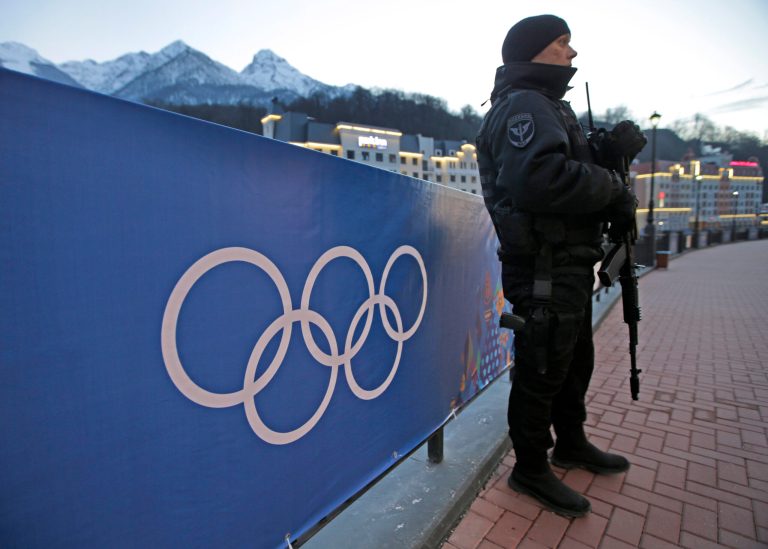 An armed Russian security guard stands at the ski resort Rosa Khutor, where the snow and sliding sports venues for the 2014 Winter Olympics are located, Tuesday, Feb. 4, 2014, in Krasnaya Polyana, Russia. (AP Photo/Dita Alangkara)