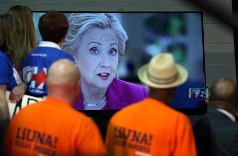Supporters watch a video as they wait for Democratic presidential candidate Hillary Clinton to speak at a campaign rally Wednesday, May 11, 2016, in Blackwood, N.J. (AP Photo/Mel Evans)