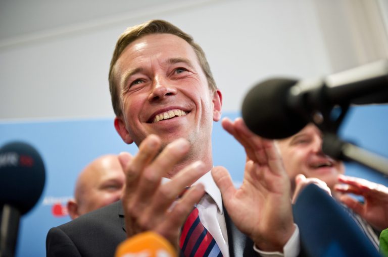 The head of the Alternative fuer Deutschland , AfD, party, Bernd Lucke,  celebrates after the first exit polls for the Saxony State election , in Berlin, Sunday Aug. 31, 2014. Exit polls say the  party that wants Germany to ditch the euro currency will be elected to a state assembly for the first time. The polls indicate that the party, Alternative for Germany, won 10 percent of the vote in Sunday's elections for the Saxony state parliament.  (AP Photo/dpa, Daniel Naupold)