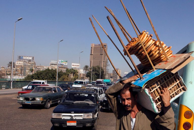 FILE -- In this Monday, March 25, 2013 file photo, an Egyptian bread vender looks for clients on a bridge over the Nile in Cairo, Egypt. A team from the International Monetary Fund left Egypt on Tuesday without securing broad backing from the country's opposition for the government's economic plan, suggesting that a key $4.8 billion loan request still hinges on austerity measures that threaten to unleash more political turmoil. Half of the country's 85 million people live at or below the poverty line of $2 a day and rely on government subsidies of wheat and fuel for survival. (AP Photo/Amr Nabil, File)