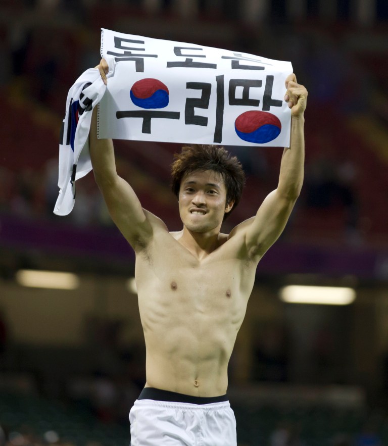   FILE - This is a Friday, Aug. 10, 2012 file photo of South Korea's Park Jong-woo as he holds up a banner reading 
