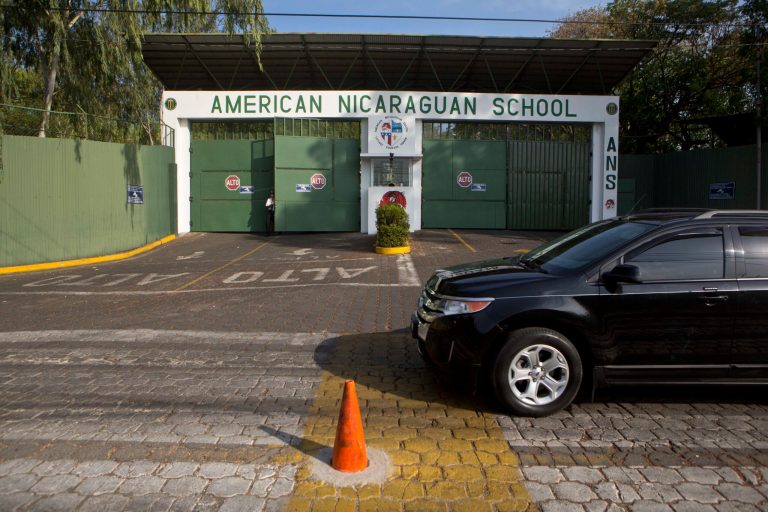 FILE - This Wednesday, May 7, 2014 file photo, shows the main entrance gate of the American Nicaraguan School, one of the international schools that hired a teacher believed to be one of the most prolific pedophiles in memory, in Managua, Nicaragua. The American Nicaraguan School said in an email to parents and staff Tuesday, May 20, 2014, that director Gloria Doll resigned, effective June. (AP Photo/Esteban Felix, File)