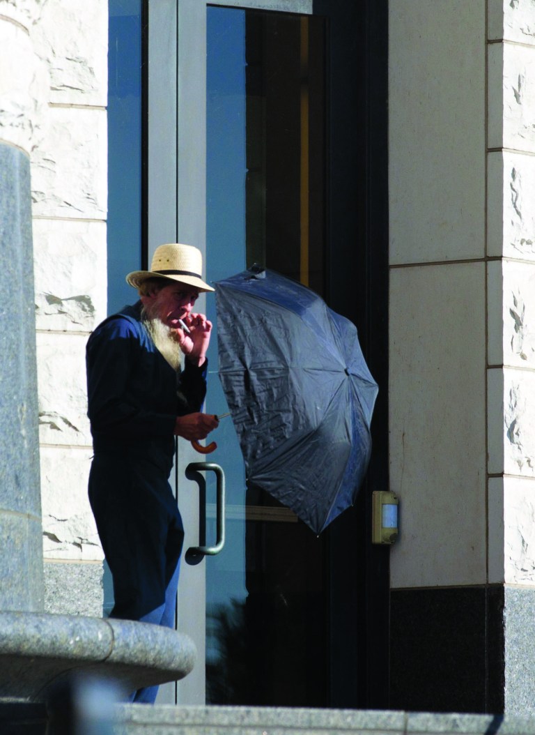 An Amish man takes a smoke break outside the U.S. Federal Courthouse in Cleveland on Wednesday, Sept. 19, 2012. The jury finished their fourth day of deliberations without a verdict in the trial of 16 people accused of hate crimes in hair- and beard-cutting attacks against fellow Amish in Ohio. (AP Photo / Scott R. Galvin)