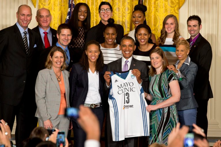 President Barack Obama holds up a Minnesota Lynx team basketball jersey for group photo during a ceremony honoring the WNBA Champion Minnesota Lynx, Thursday, June 12, 2014, in the East Room of the White House in Washington. Minnesota Lynx defeated the Atlanta Dream last October to win their second WNBA title in three years. (AP Photo/Jacquelyn Martin)