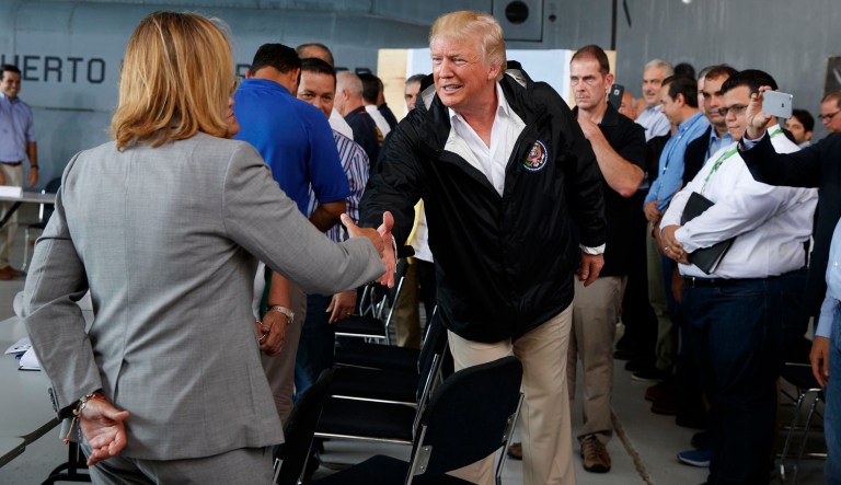 President Trump shakes hands with San Juan Mayor Carmen Yulin Cruz during a briefing on hurricane recovery efforts with first responders at Luis Muniz Air National Guard Base, Tuesday, Oct. 3, 2017, in San Juan, Puerto Rico. (AP Photo/Evan Vucci)