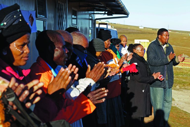 Mandla Mandela, right, the grandson of former South African President Nelson Mandela claps hands with children and other adults during celebrations for Mandela's birthday in Mvezo, South Africa, Wednesday, July 18, 2012. Across the country, and even abroad, people are doing good deeds to honor the country's most famous statesman on his 94th birthday Wednesday. (AP Photo/Schalk van Zuydam)