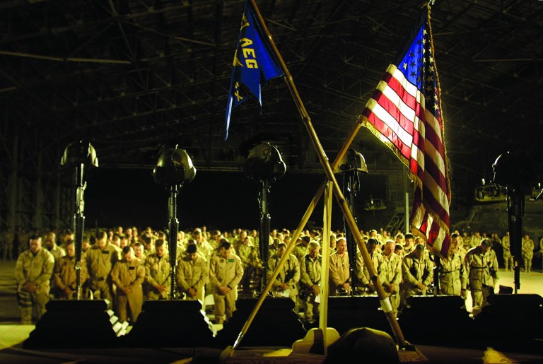 FILE - In this March 26, 2003 file photograph, U.S. Military personnel pray as they attend the memorial service for their their comerades in Kandahar, Afghanistan. .U.S. military deaths in Afghanistan have surpassed 2,000, a grim reminder that a war which began nearly 11 years ago shows no signs of slowing down despite an American decision to begin the withdrawal of most of its combat forces. (AP Photo/Gurinder Osan, File)