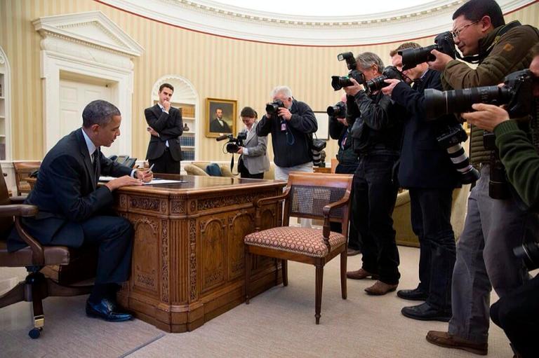 The White House on Thursday hit back at claims from media organizations that they have not allowed sufficient access to photojournalists by tweeting a picture of President Obama being photographed by the press in the Oval Office.
The photo, tweeted by official White House photographer Pete Souza, shows Obama signing a bill as a pack of photographers for news organizations record the moment.