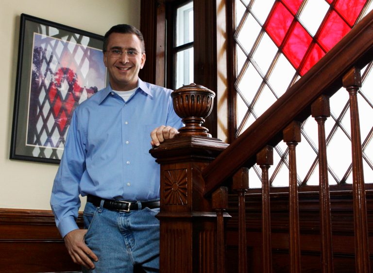 Jonathan Gruber poses in his home in Lexington, Mass. Newly surfaced videos have revived the push by congressional conservatives to repeal President Obama's healthcare law, about to begin its second year of coverage for millions of Americans. (AP Photo)