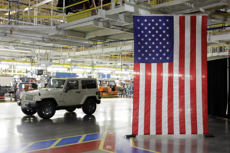 FILE - In this June 3, 2011 file photo, a 2012 Jeep Wrangler sits next to the assembly line at Chrysler Group's Toledo Assembly complex, in Toledo, Ohio. Word that Chrysler is considering moving production of the Wrangler elsewhere so that the famously rugged vehicle can be constructed with an aluminum body to meet new government gas-mileage standards has triggered feelings of anger, betrayal and despair in this Midwestern industrial city. (AP Photo/Paul Sancya, File)