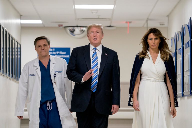 President Donald Trump, center, accompanied by and first lady Melania Trump, right, and Dr. Igor Nichiporenko, left, speak to reporters while visiting with medical staff at Broward Health North in Pompano Beach, Fla., Friday, Feb. 16, 2018, following Wednesday's shooting at Marjory Stoneman Douglas High School, in Parkland, Fla. (AP Photo/Andrew Harnik)