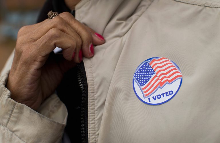 A voter shows off her sticker as she leaves a polling place on November 4, 2014. (Getty images/Scott Olson)