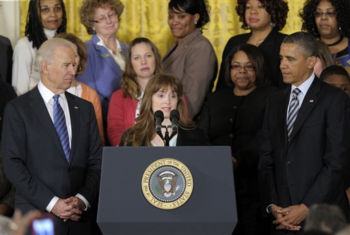 Katerina Rodgaard, center, a Maryland dance instructor who knew one of the victims of the Virginia Tech shootings, accompanied by President Barack Obama, Vice President Joe Biden, and others, who according to the White House, law enforcement officials, victims of gun violence, and others, speaks in the East Room of the White House in Washington, Thursday, March 28, 2013, where Obama urged Congress to take action on measures to protect children from gun violence. (AP Photo/Susan Walsh)