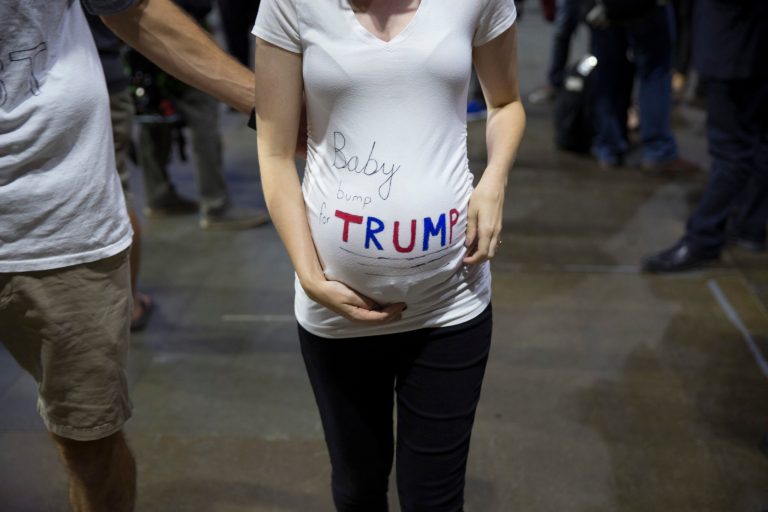 Kendra Wright, of Auburn, Wash., listens to Republican presidential candidate Donald Trump speak during a campaign rally at Xfinity Arena of Everett, Tuesday, Aug. 30, 2016, in Everett, Wash. (AP Photo/Evan Vucci)