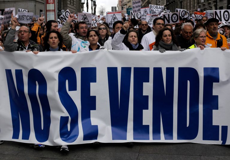   Protestors hold a banner reading, 'Not for sale' during a demonstration against regional government-imposed austerity plans to restructure and part-privatize health care sector in Madrid, Spain, Sunday, Dec. 16, 2012. Madrid proposes selling off the management of six of 20 public hospitals and 27 of 268 health centers. Spain's regions are struggling with a combined debt of 145 billion euro ($190 billion) as the country's economy contracts into a double-dip recession triggered by a 2008 real estate crash. (AP Photo/Andres Kudacki)  