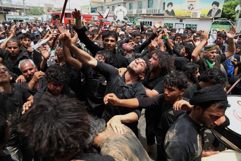 Shiite pilgrims beat themselves as a sign of grief outside the holy Shiite shrine of Imam Moussa al-Kadhim, in Baghdad, Iraq, Saturday, May 24. (AP Photo/ Karim Kadim)