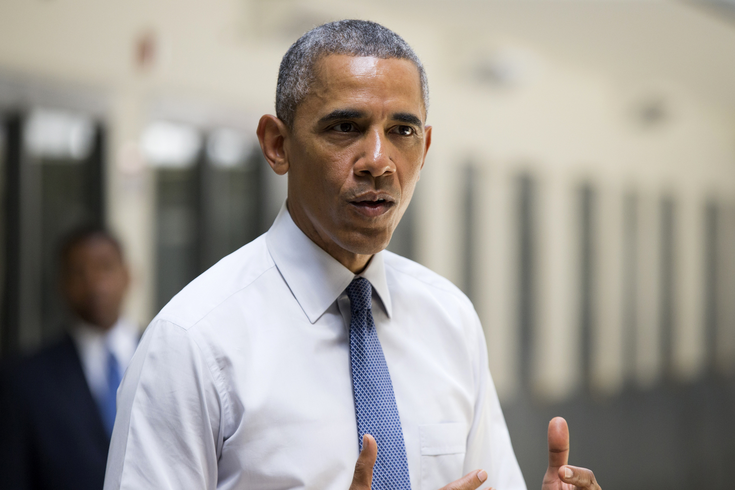 Obama defends move to free 53 felons with gun charges