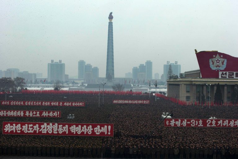   Slogans honoring the leadership and celebrating the successful rocket launch of a satellite are displayed during a mass rally on Kim Il Sung Square in Pyongyang, North Korea, Friday, Dec. 14, 2012. As the U.S. led international condemnation of what it calls a covert test of missile technology, top North Korean officials denied the allegations and maintained the country's right to develop its space program. (AP Photo/Ng Han Guan)  