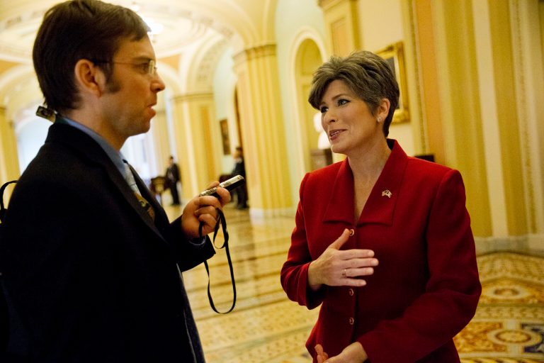 Sen.-elect Joni Ernst R-Iowa, right, talks with a reporter on Capitol Hill in Washington, Tuesday, Jan. 6, 2015, before being sworn-in for the 114th Congress in Washington. (AP Photo/Jacquelyn Martin)