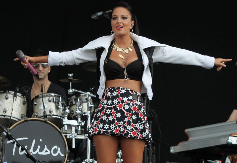FILE - A Saturday, July 7, 2012 photo from files showing British singer Tulisa Contostavlos performing on stage at the 2012 Wireless Music Festival in Hyde Park, central London. British media said Tuesday, June 4, 2013 that singer and former 
