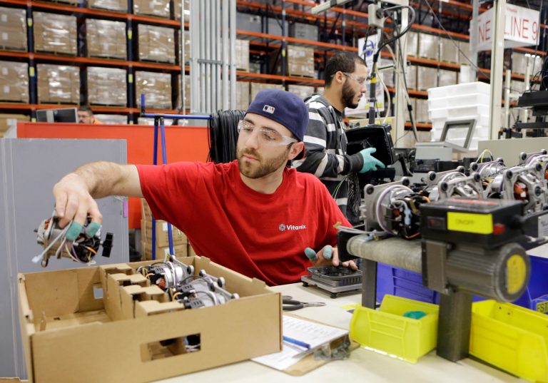 In this April 15, 2014 photo, Anthony Zingale wires blender motors at the Vitamix manufacturing facility in Strongsville, Ohio. The Labor Department releases the Producer Price Index for April on Wednesday, May 14, 2014. (AP Photo/Mark Duncan)