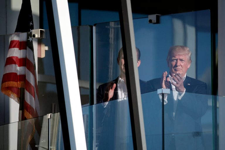 President Donald Trump applauds as he watches play on the 14th hole during the final round of the Presidents Cup golf tournament at Liberty National Golf Club in Jersey City, N.J., Sunday, Oct. 1, 2017. (AP Photo/Julio Cortez)