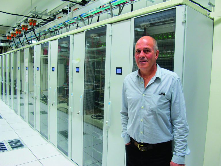 In this Nov. 14, 2012 photo, Weta Digital General Manager Tom Greally stands in front of a large bank of servers with the computing power of 30,000 laptops used for animation work in the companies Wellington studios in New Zealand. Weta Digital is the centerpiece of a filmmaking empire that Peter Jackson and close collaborators have built in his New Zealand hometown, realizing his dream of bringing a slice of Hollywood to Wellington. It's a one-stop shop for making major movies - not only his own, but other blockbusters like 
