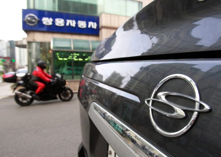 Ssangyong Motor Co. emblem is seen on its car in front of the company's showroom in Seoul, South Korea, Friday, Feb. 7, 2014.  Seoul High Court said a layoff of 153 workers at Ssangyong Motor Co. is not valid because the company has not been in financial risk that makes the workforce cut vital to survival. The company said it will appeal to the Supreme Court and denied its losses were overstated. (AP Photo/Ahn Young-joon)