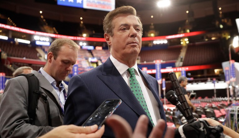 Donald Trump's campaign chairman Paul Manafort and Rick Gates were told to surrender to federal authorities on Monday. (AP Photo/Matt Rourke)